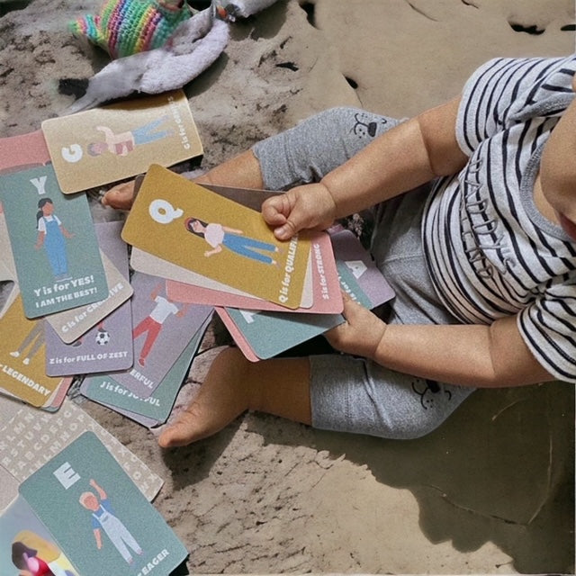 Child playing with alphabet affirmation cards