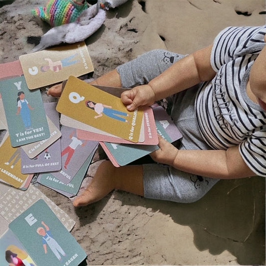 Child playing with alphabet affirmation cards